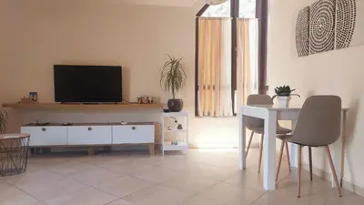 a living room with a television and a table and chairs at Mila's studio in Kotor