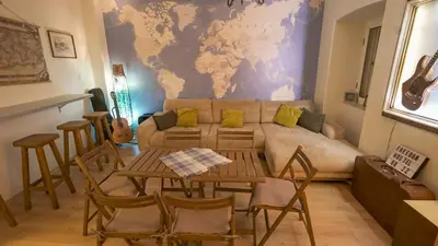 a living room with a couch and a table at FREEDOM HOSTEL in Budva