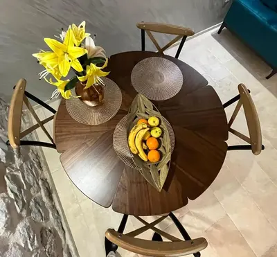 a wooden table with a bowl of fruit and flowers at Casa Vecchia in Kotor