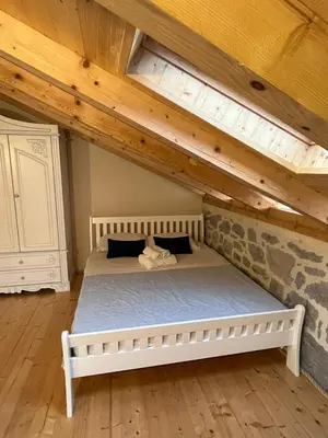 a bed in a room with a wooden ceiling at Casa Vecchia in Kotor