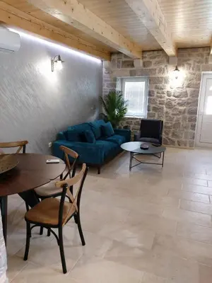 a living room with a blue couch and a table at Casa Vecchia in Kotor