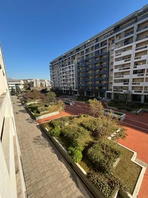 a view of a building with trees and a street at Apartman Ana Lux in Podgorica