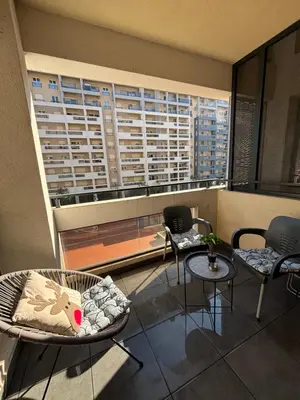 a room with chairs and tables and a large window at Apartman Ana Lux in Podgorica