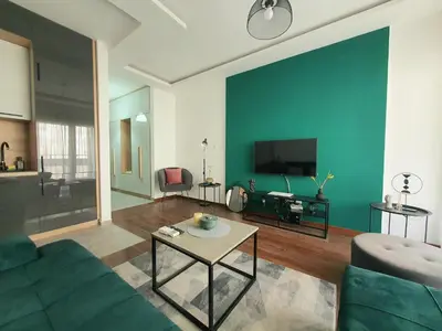 a living room with a couch and a tv at Apartman Ana Lux in Podgorica
