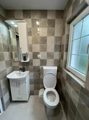a bathroom with a toilet and a sink and a window at Dolce Casa in Kotor