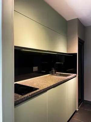 a kitchen with white cabinets and a counter top at Anja & Ogo apartments with Pool _ in Petrovac na Moru