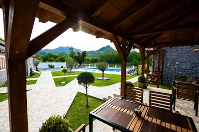 an outdoor patio with a wooden table and benches at Lake Valley in Virpazar