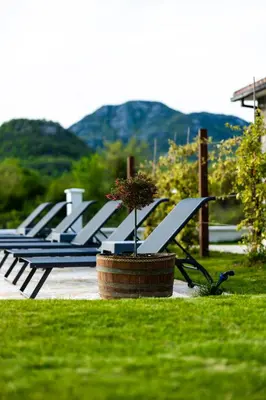 a row of empty benches in a park at Lake Valley in Virpazar