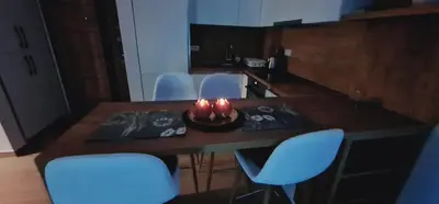 a table with chairs and a bowl with candles on it at SeaView Apartment & Pool in Ulcinj