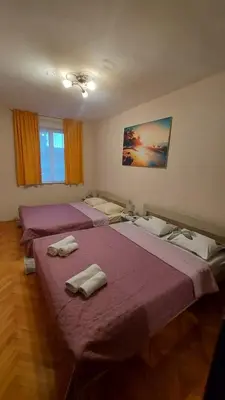 a room with three beds with towels on them at DUBLIN STAN na dan u MARŠALA TITA in Bar