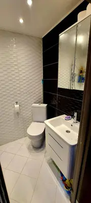 a bathroom with a white toilet and a sink at DUBLIN STAN na dan u MARŠALA TITA in Bar