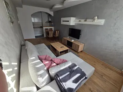 a living room with a couch and a television at DUBLIN STAN na dan u MARŠALA TITA in Bar