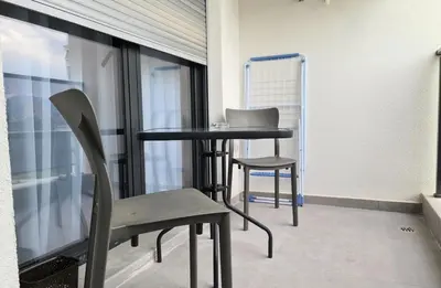 a table and chairs in a room with a window at Green Apartments Podgorica With Garage in Podgorica