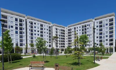 a large apartment building with a park in front of it at Green Apartments Podgorica With Garage in Podgorica