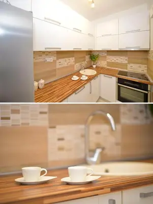 a kitchen with white cabinets and two cups on a counter at Apartment Filip in Kotor
