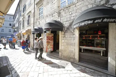 a group of people standing in front of a store at Apartment Filip in Kotor