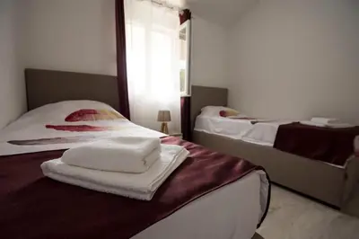 two beds in a room with towels on the bed at Eco Village experience - Skadar Lake in Virpazar