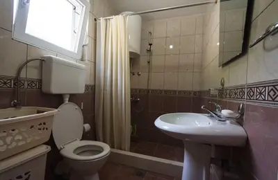 a bathroom with a toilet and a sink and a shower at Eco Village experience - Skadar Lake in Virpazar