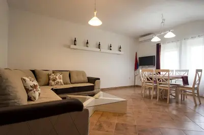 a living room with a couch and a table at Eco Village experience - Skadar Lake in Virpazar