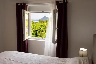 a bedroom with a bed and a window with a view at Eco Village experience - Skadar Lake in Virpazar