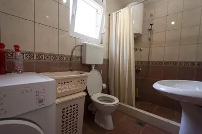 a small bathroom with a toilet and a sink at Eco Village experience - Skadar Lake in Virpazar