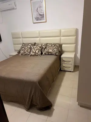a bedroom with a large bed with a large headboard at ApartsDobraVoda in Dobra Voda