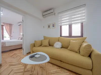 a living room with a couch and a table at Oscar Exclusive Apartment in Budva