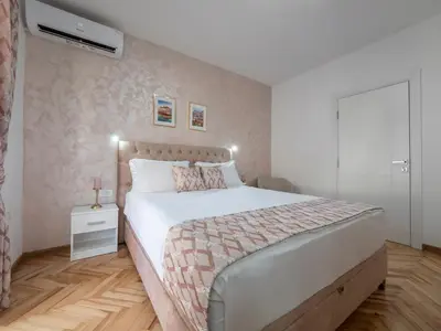 a bedroom with a large bed in a room at Oscar Exclusive Apartment in Budva