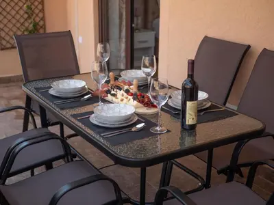 a table with a bottle of wine and a plate of food at Oscar Exclusive Apartment in Budva