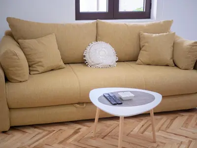 a couch with a white coffee table in a living room at Oscar Exclusive Apartment in Budva