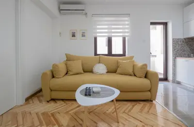 a living room with a couch and a table at Oscar Exclusive Apartment in Budva