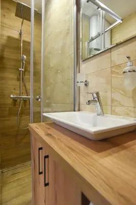 a bathroom with a white sink and a shower at Sambra old town apartment in Budva