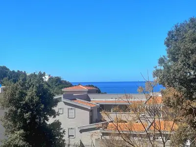 a building with the ocean in the background at Beach Bliss in Utjeha