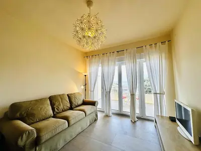 a living room with a couch and a chandelier at Beach Bliss in Utjeha