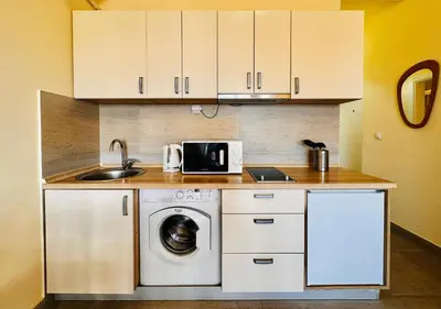 a kitchen with a washing machine and a sink at Beach Bliss in Utjeha