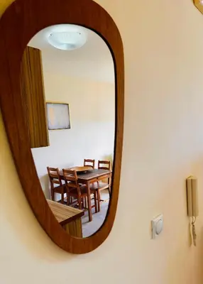 a mirror on a wall with a table and chairs at Beach Bliss in Utjeha