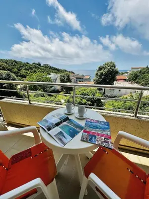 a white table and two chairs on a balcony at Beach Bliss in Utjeha