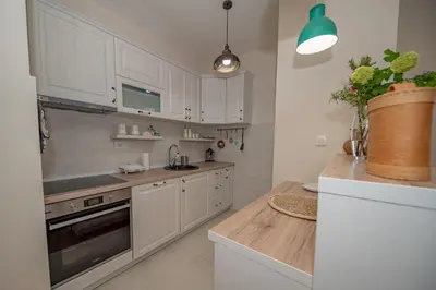 a kitchen with white cabinets and a counter top at Un posto al sole in Bar