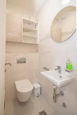 a bathroom with a toilet and a sink and a mirror at Un posto al sole in Bar