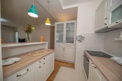 a kitchen with white cabinets and a counter top at Un posto al sole in Bar