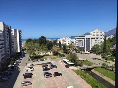 a parking lot with parked cars in a city at Un posto al sole in Bar