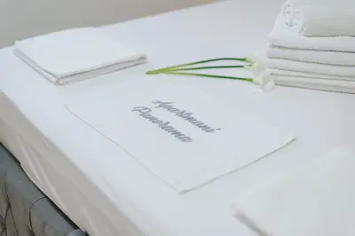 a table with towels and a paper on it at Apartmani Panorama in Bar
