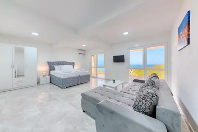 a large living room with a couch and a bed at Apartmani Panorama in Bar