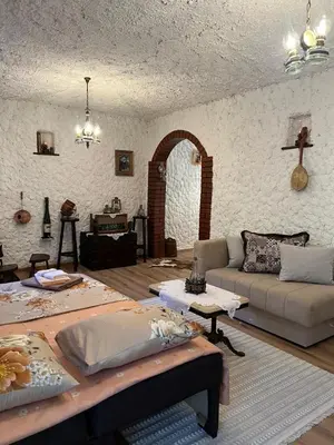 a living room with a couch and a table at Sailor's Rustic House in Virpazar