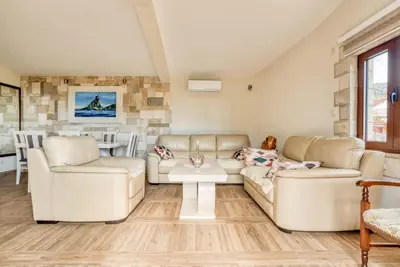 a living room with two couches and a table at SAVOVIC_LUX in Petrovac na Moru