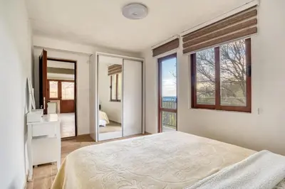 a bedroom with a bed and a large window at SAVOVIC_LUX in Petrovac na Moru