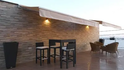 a group of chairs and a table on a patio at Lux Seky with Pool in Dobra Voda