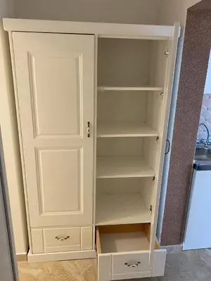a white cabinet with empty shelves in a room at Lux Seky with Pool in Dobra Voda