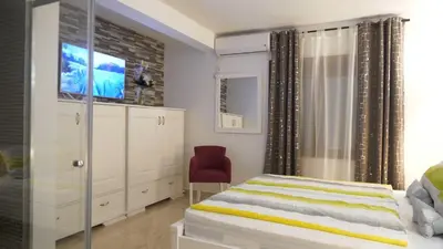 a bedroom with a bed and a tv in it at Lux Seky with Pool in Dobra Voda