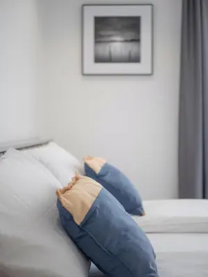 a white couch with blue pillows on it at Horizon-One bedroom apartment with pool Jane in Becici